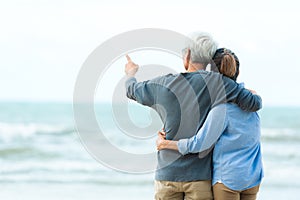 Asian Lifestyle senior couple hug on the beach happy in love romantic and relax time.Â  Tourism elderly family travel leisure and